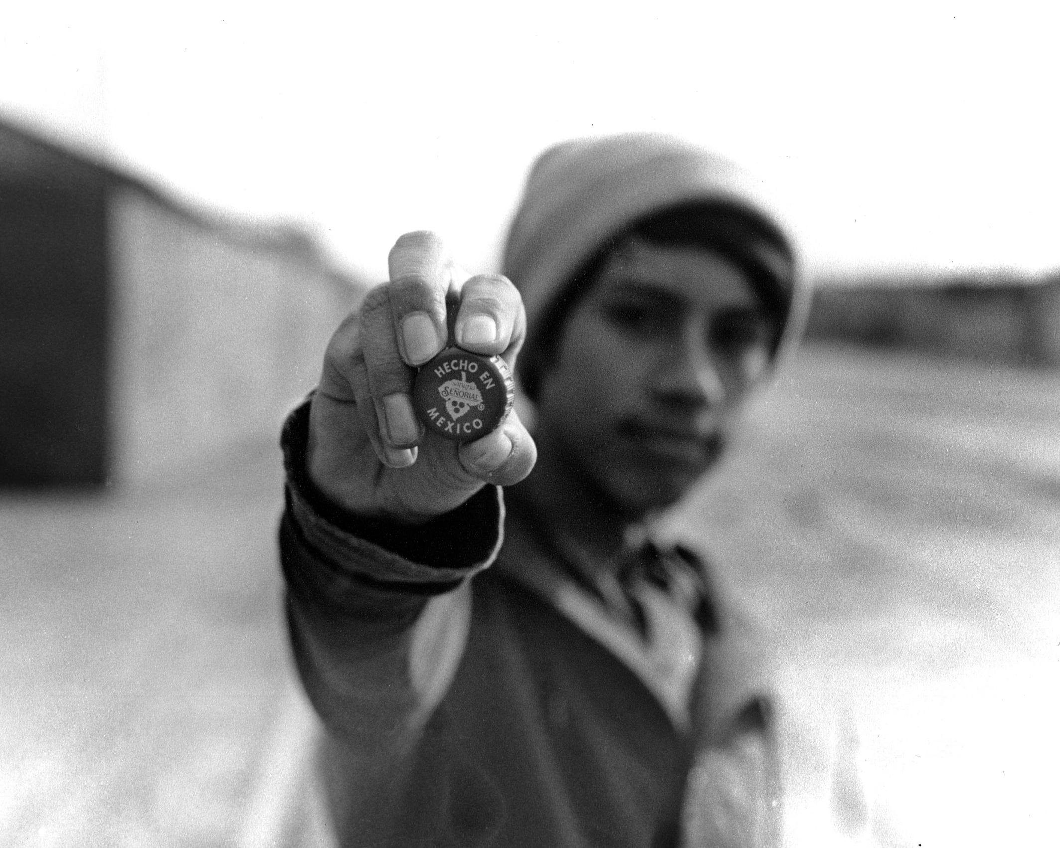 A person holding up a small object.